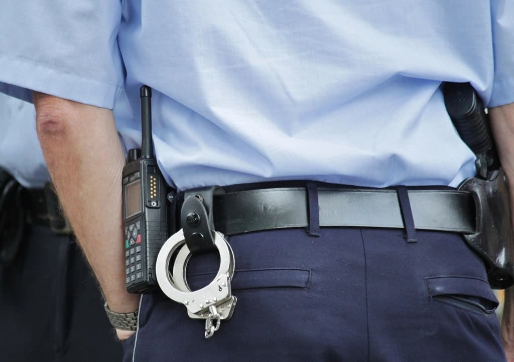 Officer's duty belt with radio and handcuffs